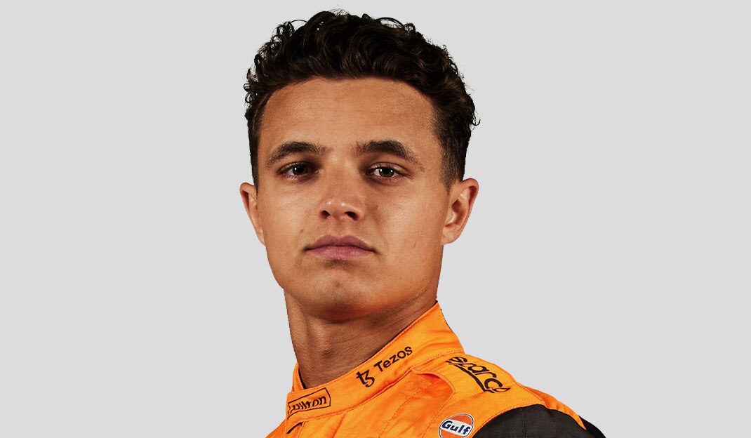McLaren Racing driver Lando Norris in an orange and black jacket.