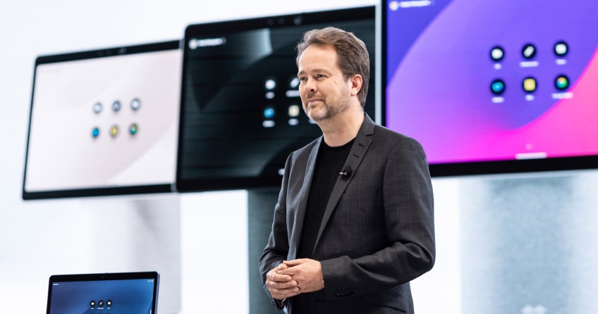 An individual presents onstage at WebexOne